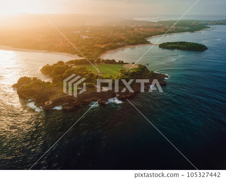 Aerial view of scenic coastline with islands, sunset tones and ocean in Nusa Dua, Bali Aerial view of scenic coastline with islands, sunset tones and ocean in Nusa Dua, Bali 105327442