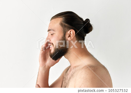 Side view of handsome smiling man having beard with closed eyes over grey background. Side view of handsome smiling man having beard with closed eyes over grey background. 105327532