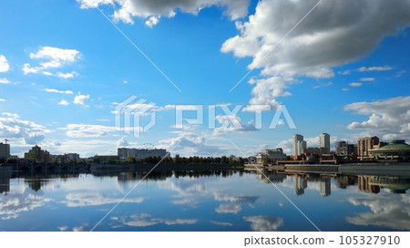 Buildings on the riverbank under a cloudy landscape Buildings on the riverbank under a cloudy landscape 105327910