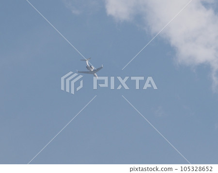 A passenger plane with a T-tail and rear engine flying over Kawaguchi City, Saitama Prefecture A passenger plane with a T-tail and rear engine flying over Kawaguchi City, Saitama Prefecture 105328652