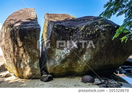 Splitted stone at Abraao Preta beach on big island Ilha Grande in Angra dos Reis, Rio de Janeiro, Brazil 105328678