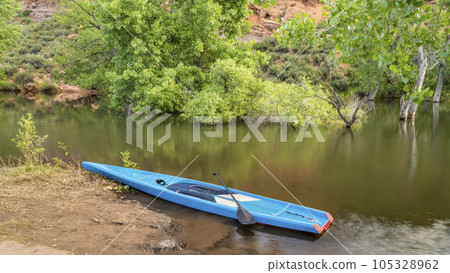 touring stand up paddleboard on a lake at Colorado foothills - Horsetooth Reservoir in summer scenery 105328962