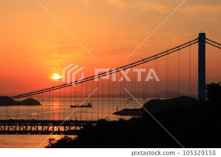 Sunset over the Seto Ohashi Bridge and a ship running in the Seto Inland Sea 105329158