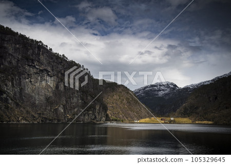 Fjord and traditional buildings on Norwegian coast 105329645