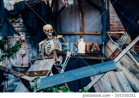 Outdoor Decor for Halloween. skeletons climbing out of the different wooden rubble. Halloween scenery. Terrible holiday photo zone on location for event. Traditions and decorations. Selective focus. Outdoor Decor for Halloween. skeletons climbing out of the different wooden rubble. Halloween scenery. Terrible holiday photo zone on location for event. Traditions and decorations. Selective focus. 105330281