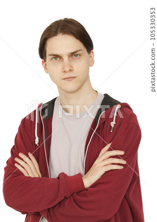 Serious puzzled young man with crossed arms portrait. Doubt, choice and think concept Serious puzzled young man with crossed arms portrait. Doubt, choice and think concept 105330353