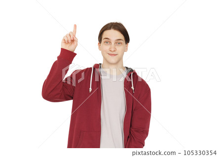 Joyful man pointing up and looking at camera isolated on white background 105330354