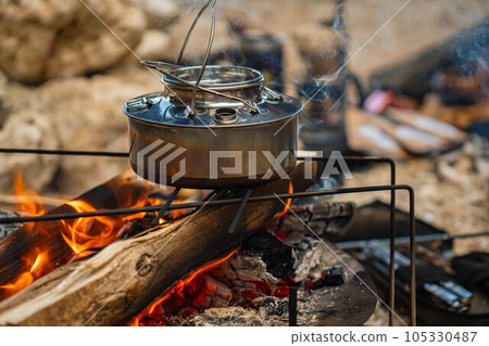 kettle camping rugged camping gear tool kettle bonfire burning flame solo camp firewood bonfire stand 105330487