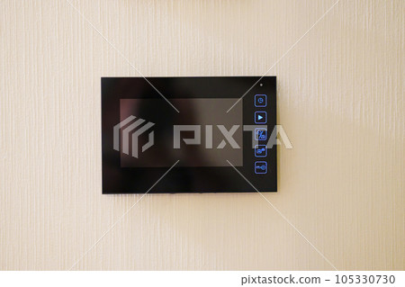 The video screen of the intercom on the wall of the house.  105330730