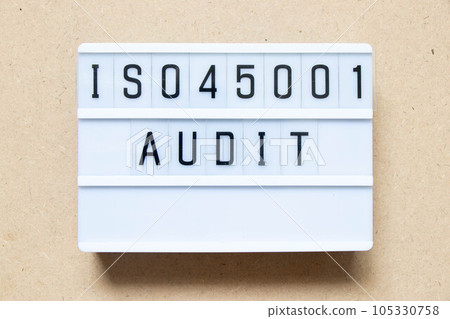Lightbox with word ISO 45001 audit on wood background 105330758