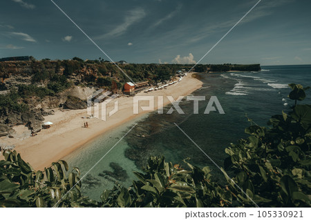 Amazing aerial Bali beach coast at ocean waves crashing to sand. Tropical paradise Indonesia island Amazing aerial Bali beach coast at ocean waves crashing to sand. Tropical paradise Indonesia island 105330921