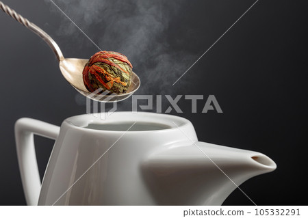 Chinese green tea ball with marigold (calendula) flowers. 105332291