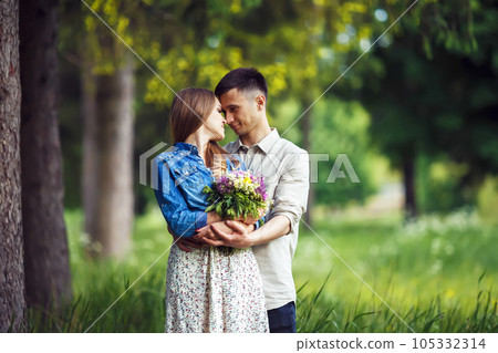 Couple in love enjoying tender moments during sunset . 105332314