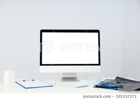 A monitor with a blank screen and a stethoscope on the table A monitor with a blank screen and a stethoscope on the table 105332371
