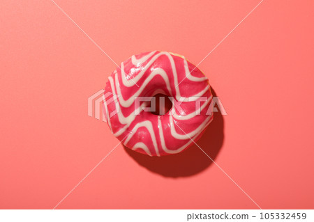 Pink glazed donut on pink background, top view 105332459
