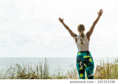 The girl does yoga in nature, near the sea 105332596