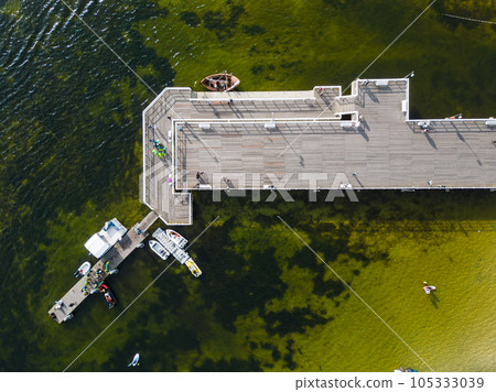 molo pier of Polish village Jastarnia, water of Baltic Sea, aerial drone view molo pier of Polish village Jastarnia, water of Baltic Sea, aerial drone view 105333039