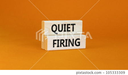 Quiet firing symbol. Concept words Quiet firing on wooden blocks. Beautiful orange table orange background. Business and quiet firing concept. Copy space. 105333309