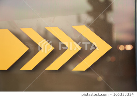 A close-up warning sign with space to copy. Exit turn sign with arrow sign on transparent glass door. High quality photo A close-up warning sign with space to copy. Exit turn sign with arrow sign on transparent glass door. High quality photo 105333334