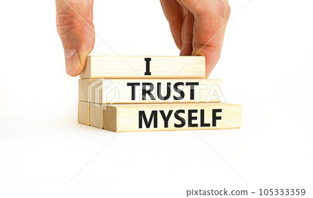 I trust myself symbol. Concept words I trust myself on wooden blocks. Businessman hand. Beautiful white table white background. Business, psychological and I trust myself concept. Copy space. 105333359