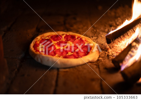 Italian pizza is cooked in oven Italian pizza is cooked in oven 105333663