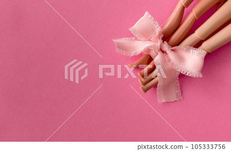 Plastic toy legs on pastel pink background. Minimal art pink poster. Space for text. High quality photo 105333756