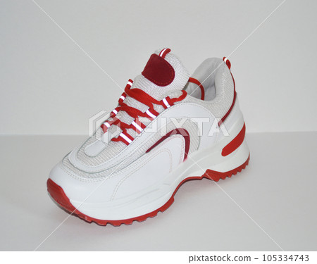 women's sneakers in red and white on a white background. Sport shoes women's sneakers in red and white on a white background. Sport shoes 105334743