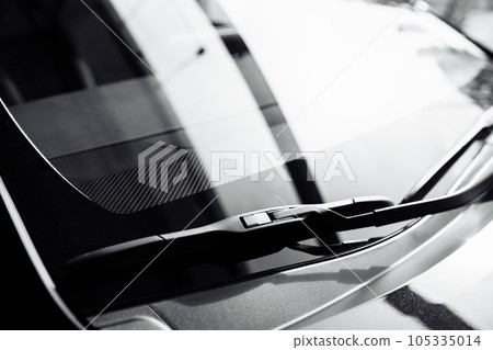 close up of front Windshield Wipers on a black new car in salon. selective focus 105335014