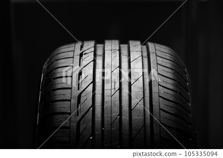 Studio shot of brand new car tire isolated on black background. close up. 105335094