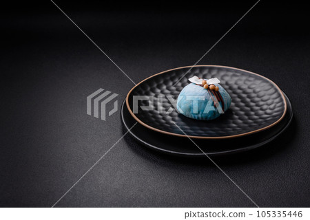 Delicious sweet colorful mochi desserts or ice cream with rice dough and toppings Delicious sweet colorful mochi desserts or ice cream with rice dough and toppings 105335446