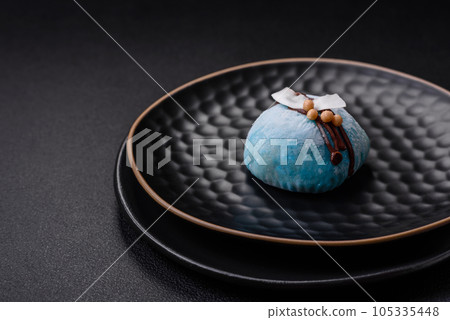 Delicious sweet colorful mochi desserts or ice cream with rice dough and toppings Delicious sweet colorful mochi desserts or ice cream with rice dough and toppings 105335448