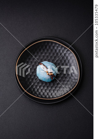 Delicious sweet colorful mochi desserts or ice cream with rice dough and toppings Delicious sweet colorful mochi desserts or ice cream with rice dough and toppings 105335479