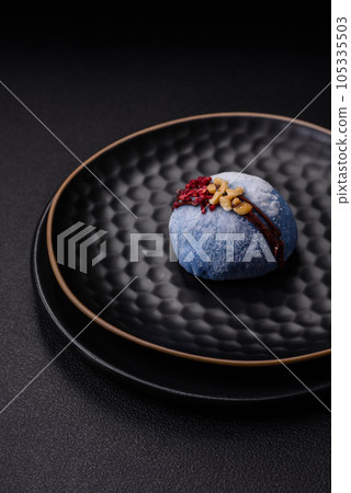 Delicious sweet colorful mochi desserts or ice cream with rice dough and toppings Delicious sweet colorful mochi desserts or ice cream with rice dough and toppings 105335503