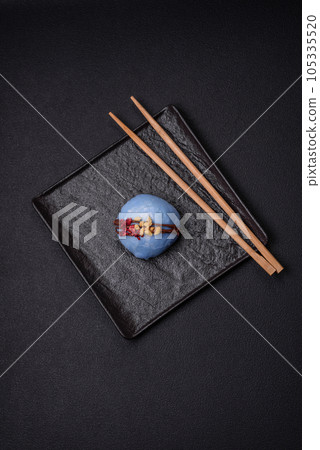 Delicious sweet colorful mochi desserts or ice cream with rice dough and toppings Delicious sweet colorful mochi desserts or ice cream with rice dough and toppings 105335520