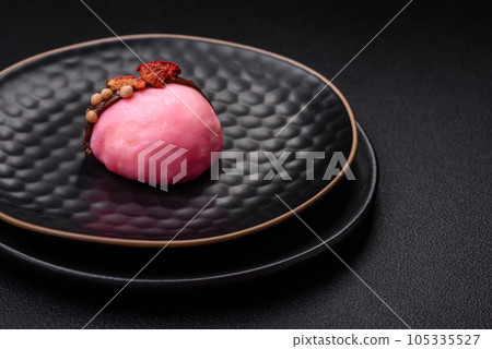 Delicious sweet colorful mochi desserts or ice cream with rice dough and toppings Delicious sweet colorful mochi desserts or ice cream with rice dough and toppings 105335527