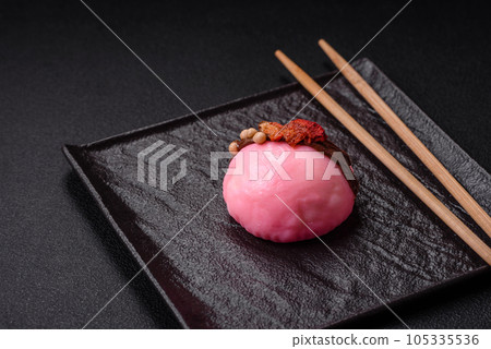 Delicious sweet colorful mochi desserts or ice cream with rice dough and toppings Delicious sweet colorful mochi desserts or ice cream with rice dough and toppings 105335536