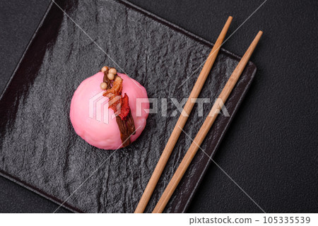 Delicious sweet colorful mochi desserts or ice cream with rice dough and toppings Delicious sweet colorful mochi desserts or ice cream with rice dough and toppings 105335539