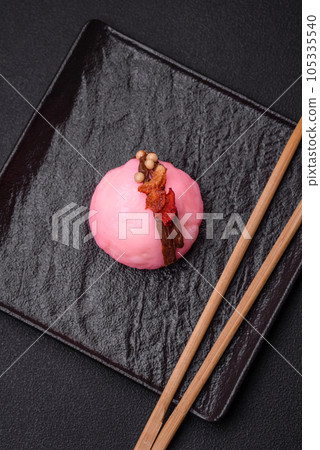 Delicious sweet colorful mochi desserts or ice cream with rice dough and toppings Delicious sweet colorful mochi desserts or ice cream with rice dough and toppings 105335540