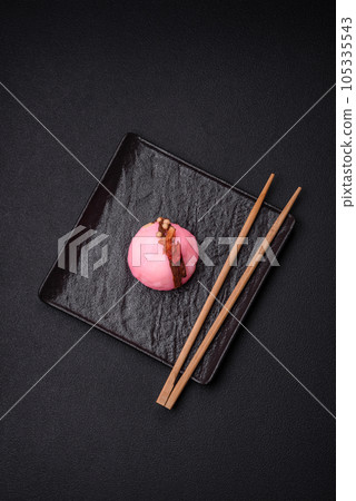 Delicious sweet colorful mochi desserts or ice cream with rice dough and toppings Delicious sweet colorful mochi desserts or ice cream with rice dough and toppings 105335543