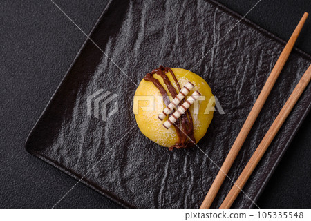 Delicious sweet colorful mochi desserts or ice cream with rice dough and toppings Delicious sweet colorful mochi desserts or ice cream with rice dough and toppings 105335548