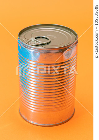 Unopened Tin Can with Blank Edge on Orange Background Unopened Tin Can with Blank Edge on Orange Background 105335688