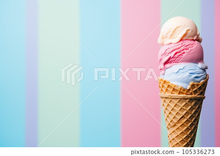 Tasty fresh fruity triple ice cream cone with cotton candy ice cream over a multicolored pastel background. Top view with copy space. Tasty fresh fruity triple ice cream cone with cotton candy ice cream over a multicolored pastel background. Top view with copy space. 105336273