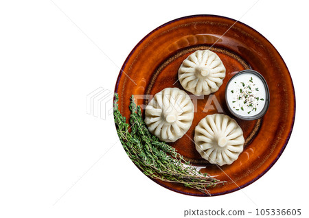 Khinkali Dumplings with beef and lamb meat on rustic plate with herbs. High quality Isolate, white background. 105336605