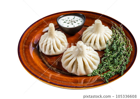 Khinkali Dumplings with beef and lamb meat on rustic plate with herbs. High quality Isolate, white background. Khinkali Dumplings with beef and lamb meat on rustic plate with herbs. High quality Isolate, white background. 105336608