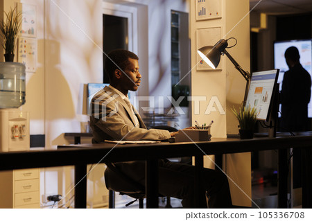 Entrepreneur typing management strategy analyzing company statistics, working overhours in startup office. Executive manager brainstorming ideas for marketing project.. Business concept Entrepreneur typing management strategy analyzing company statistics, working overhours in startup office. Executive manager brainstorming ideas for marketing project.. Business concept 105336708