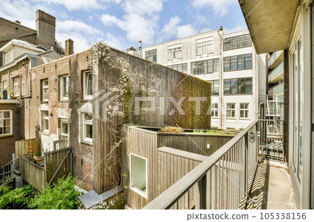 an outside area with some plants on the balcony and buildings in the background, taken from a high angle view an outside area with some plants on the balcony and buildings in the background, taken from a high angle view 105338156