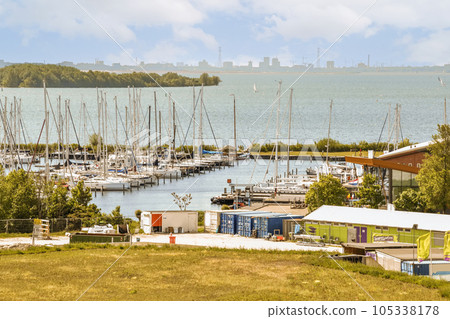 some boats docked in the water and buildings on the other side of the harbor with blue skies above them, some boats docked in the water and buildings on the other side of the harbor with blue skies above them, 105338178