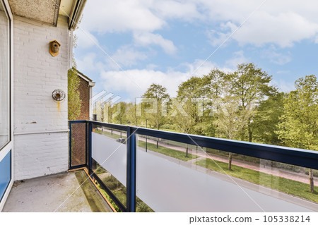 a balcony with blue railings and trees in the background on a sunny day photo taken from an apartment balcony 105338214