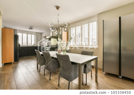 a kitchen and dining area in a house with wood floors, hardwood flooring and stainless appliances on the wall 105338450