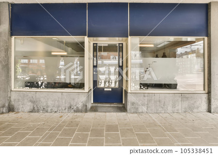 an empty store with no people in the photo, but there is a blue door that has been painted on it 105338451